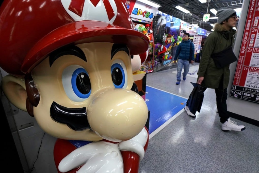 A Super Mario figure greets shoppers at an electronics store in Tokyo. Nintendo has announced it is developing a Super Mario anime film. Photo: AP