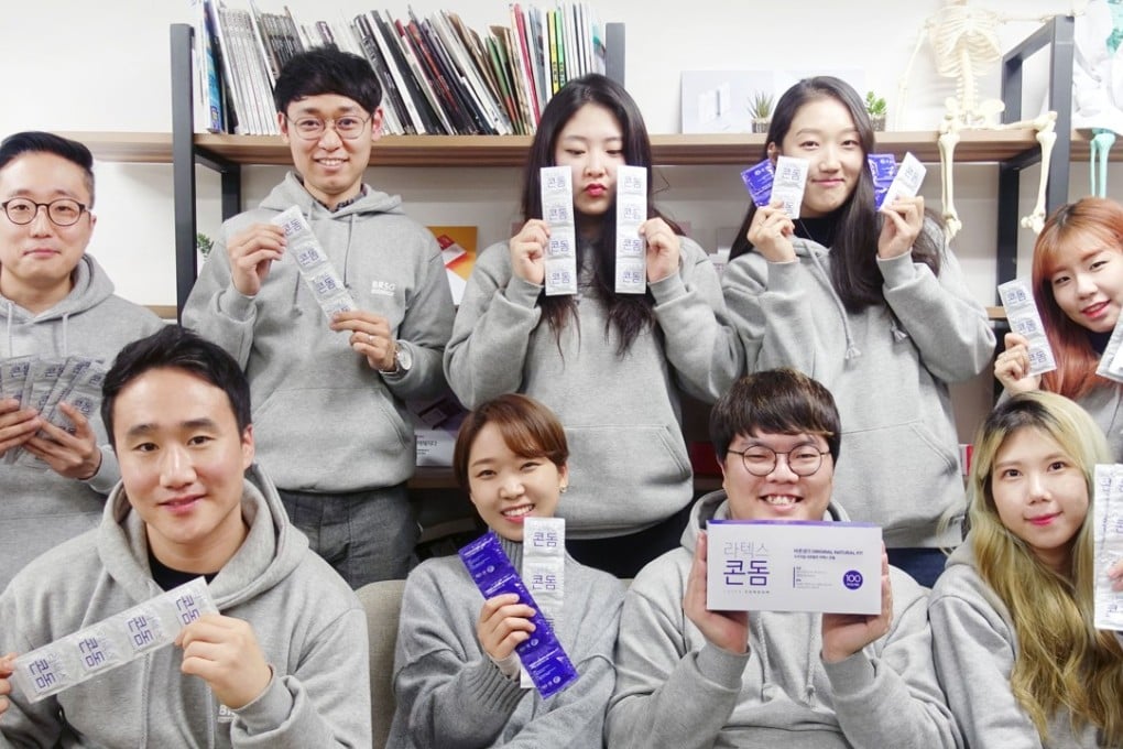 Condom company Convenience Co.’s South Korean employees display samples of its ‘original natural fit premium latex condom’. Photo: AFP