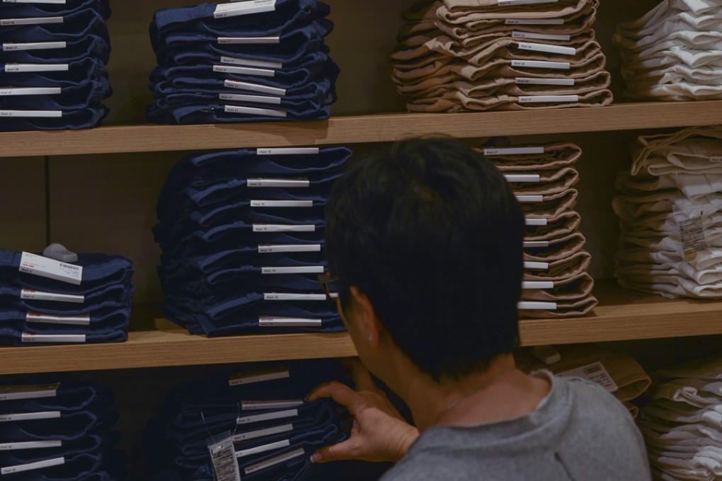 A shopper at one of the many fast-fashion retail stores in Hong Kong. Pictures: SCMP