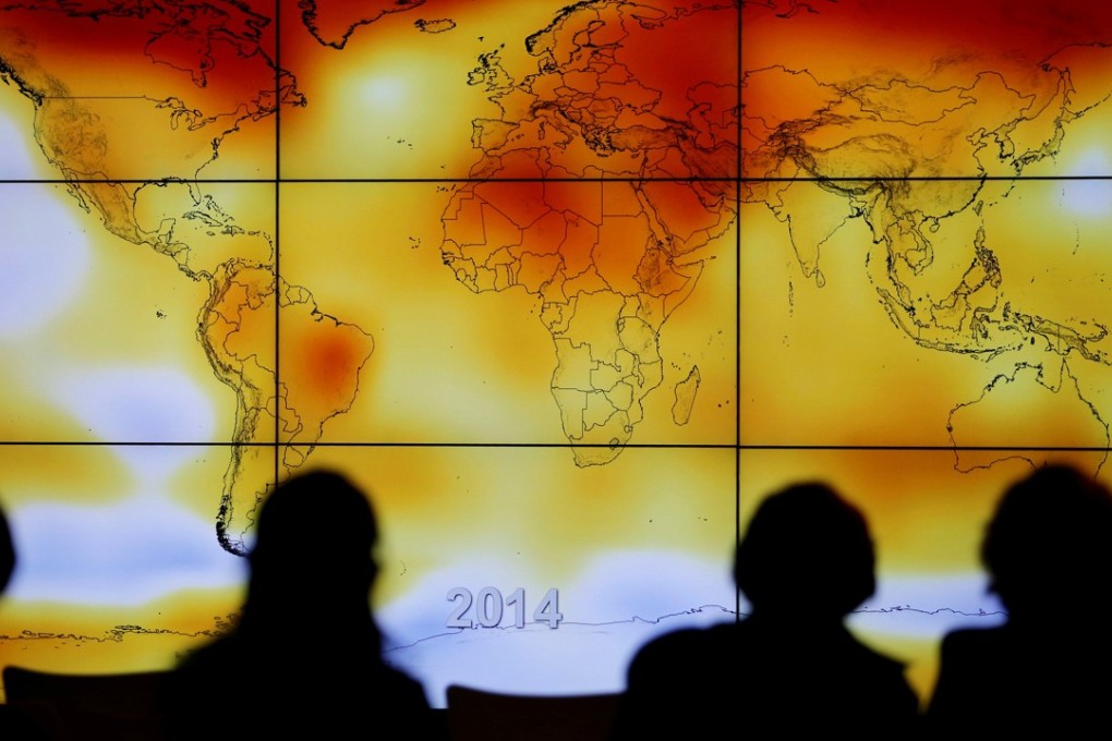 Participants look at a screen showing a world map with climate anomalies during the World Climate Change Conference 2015, near Paris in December that year. Photo: Reuters