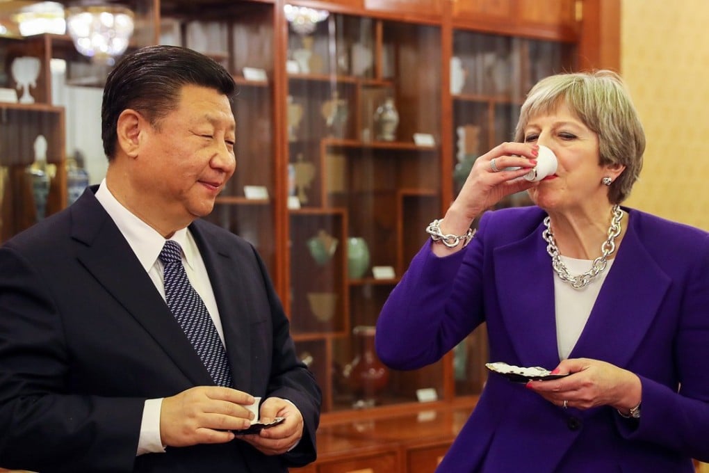 Theresa May drinks tea with Xi Jinping during a ceremony in Beijing on Thursday. Photo: Bloomberg