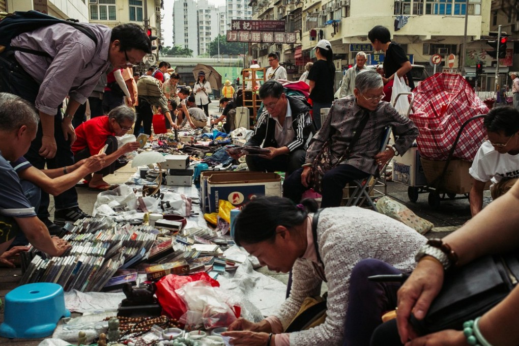 Hongkongers browse a flea market in Sham Shui Po last April. Hong Kong, a city of soaring skyscrapers and glittering luxury boutiques, is considered by some to be the epitome of income inequality in the developed world. Photo: Bloomberg