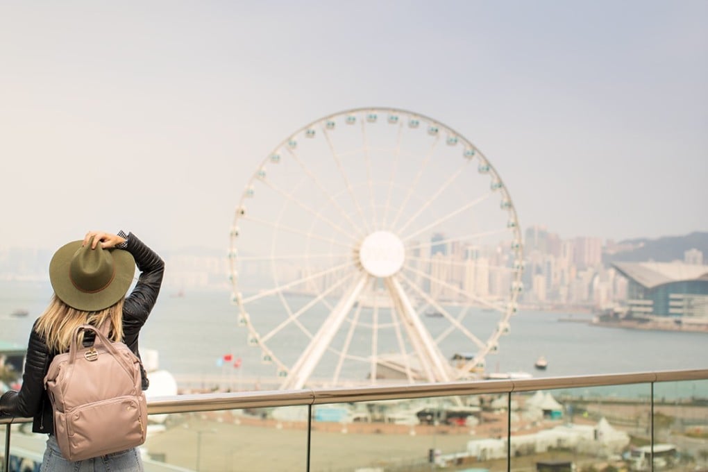 A traveller wears a Pacsafe Citysafe CX anti-theft backpack.