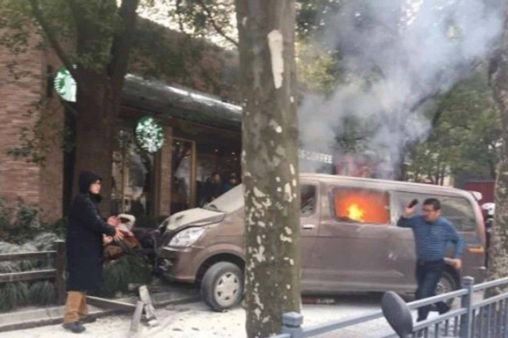 The vehicle was already on fire when it mounted the pavement and crashed into a fence outside a Starbucks outlet in the Huangpu district of Shanghai on Friday morning. Photo: Weibo