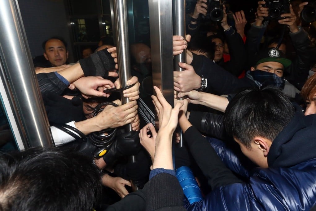 Students try to break into the venue where a meeting of the University of Hong Kong Council was being held. Photo: Sam Tsang