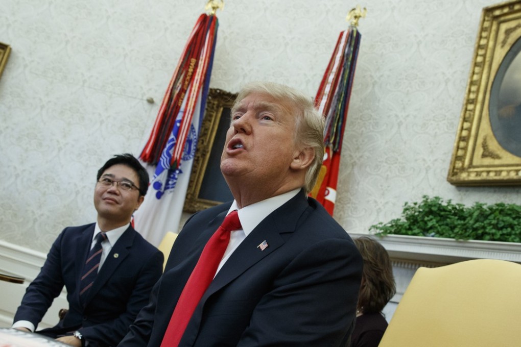 President Donald Trump speaks with reporters about allowing the release of a secret memo on the FBI’s role in the Russia inquiry during a meeting with North Korean defectors in the Oval Office of the White House on Friday. Photo: AP