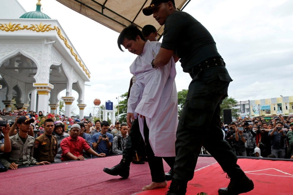 An Indonesian man is publicly caned for having gay sex. Photo: Reuters