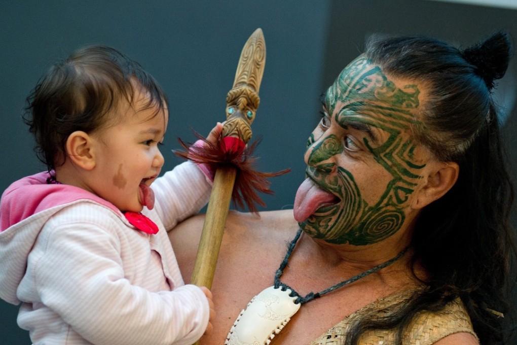 Maori Wetini Mitai-Ngatai shows his daughter Niwareka his 'war face' at the Frankfurt Book Fair, in Frankfurt on 09 October 2012. Mitai-Ngatai, along with his dance group, will accompany the German Foreign Minister for the opening of the New Zealand pavillion. Photo: EPA
