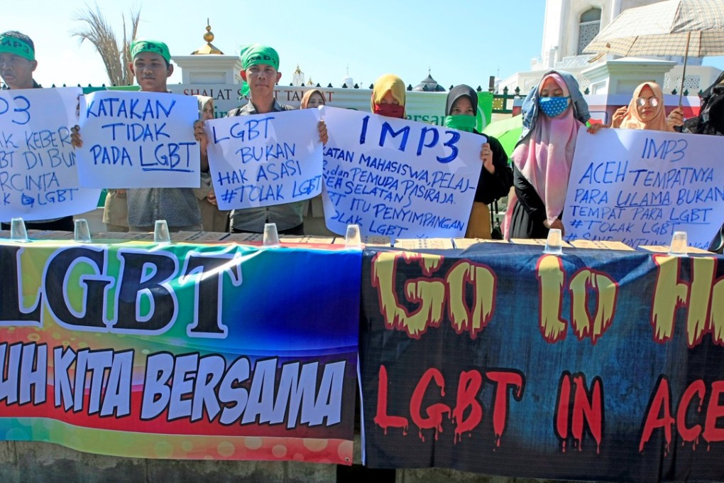 Muslim protesters hold anti-LGBT signs. Photo: Reuters