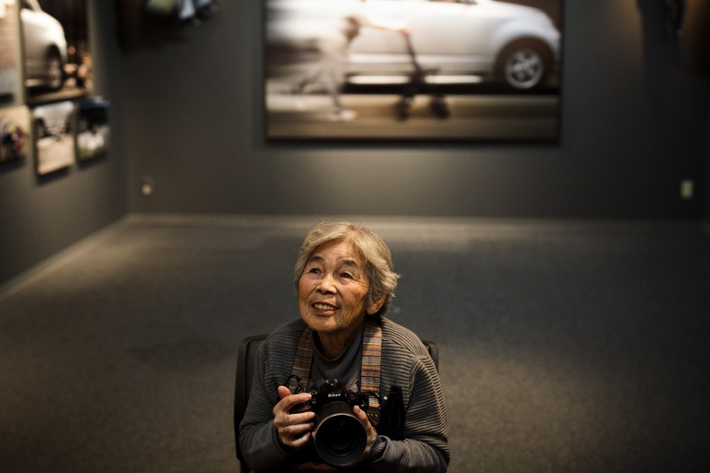 Kimiko Nishimoto poses with a camera at the opening of her recent photo exhibition in Tokyo. Photo: AFP