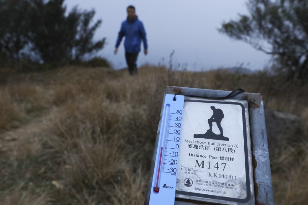 Walkers visit the peak of Tai Mo Shan to experience almost zero-degree temperatures early on Monday morning. Photo: Sam Tsang