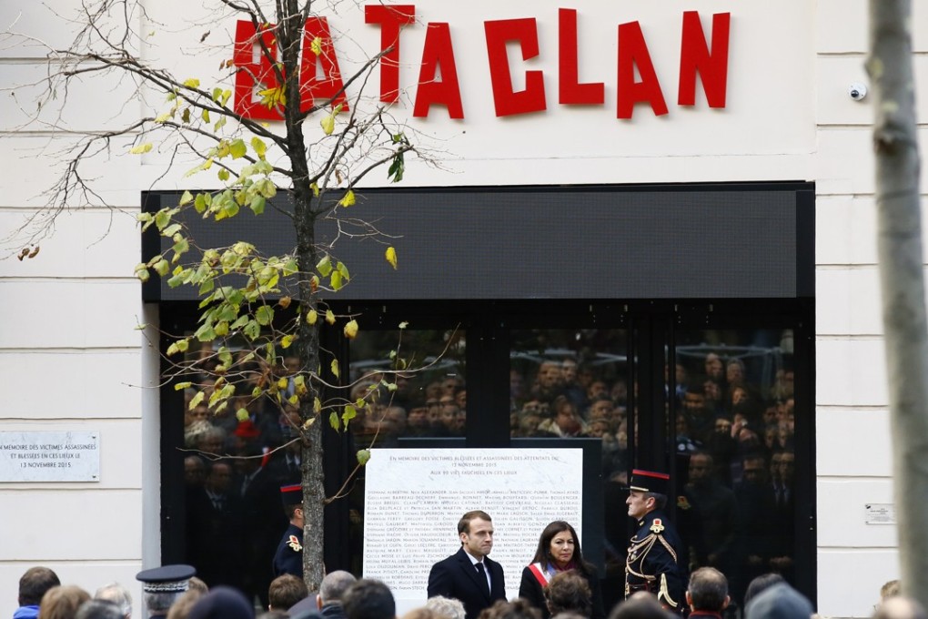 French President Emmanuel Macron, centre left, flanked with Paris mayor Anne Hidalgo stand in front of the Bataclan concert hall during a ceremony marking the second anniversary of the Paris attacks, on November13, 2017. Photo: AP