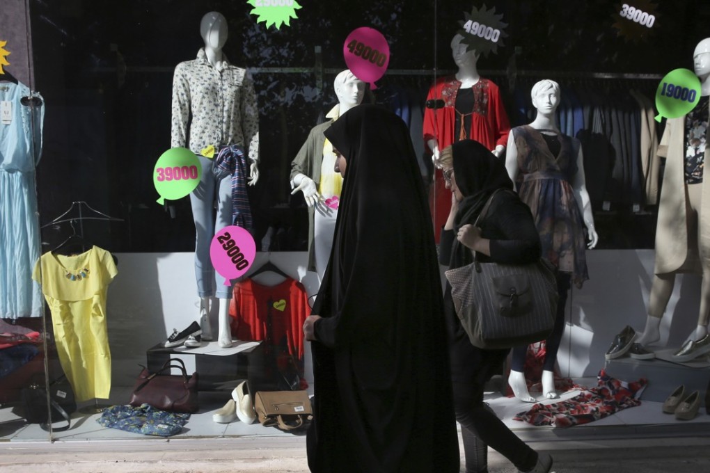 Iranian women walk past a clothes shop in downtown Tehran. Iranian state television offered a rare apology after broadcasting a professed female expert on religious issues advising women to comfort husbands by massaging and kissing their feet. Photo: AP