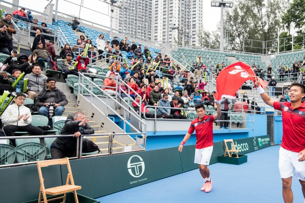 Kevin Wong (left) and Brian Yeung celebrate with the flag. Photo: Panda Man/Takumi Photography