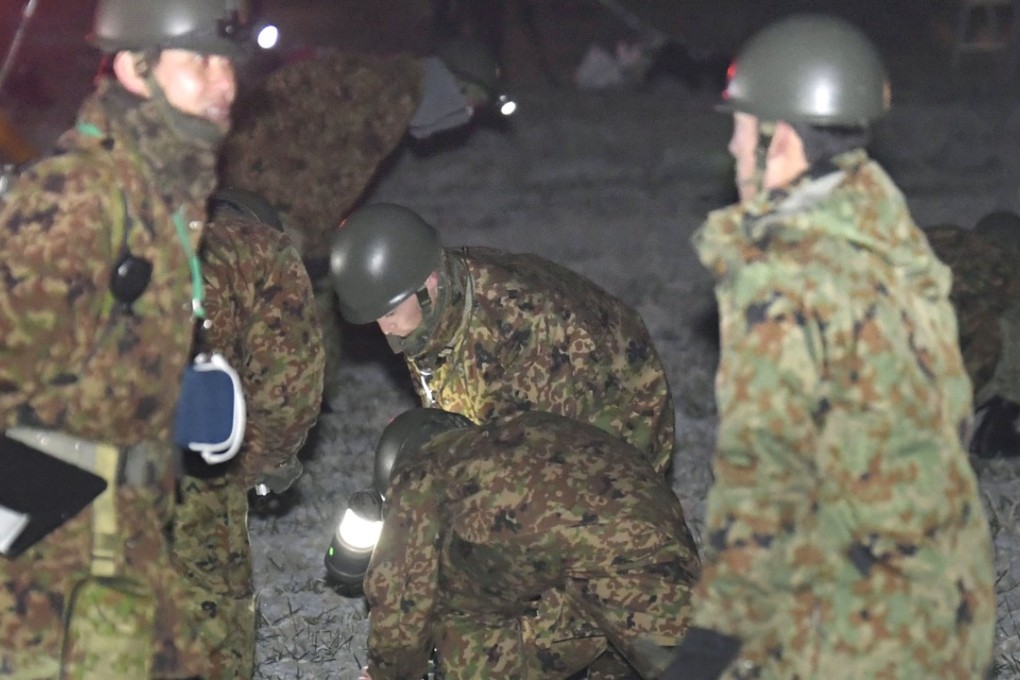 Self-Defence Force personnel search a field in Saga Prefecture for survivors of the helicopter crash. Photo: Kyodo