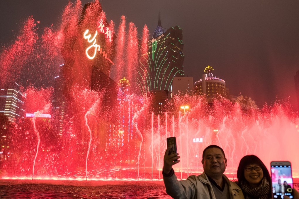 People use their smartphones to take photographs outside The Wynn Macau casino resort in Macau on January 30. Hainan wants to mimic Macau’s success as a gambling destination. File photo: Bloomberg