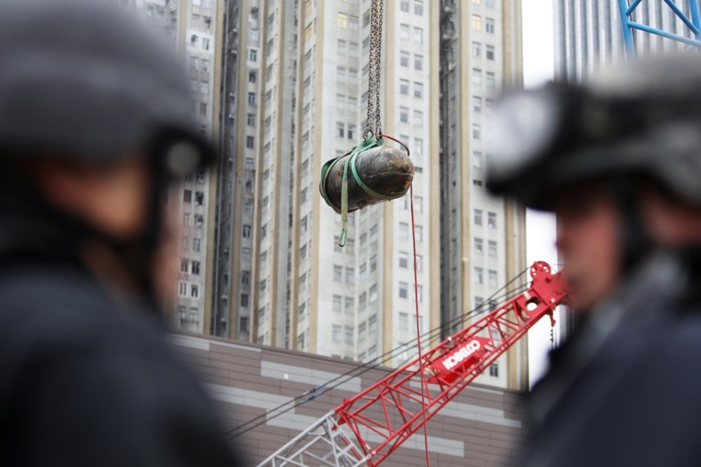 A bomb from the second world war is removed from the Sha Tin-Central rail link construction site in Wan Chai. Photo: Sam Tsang