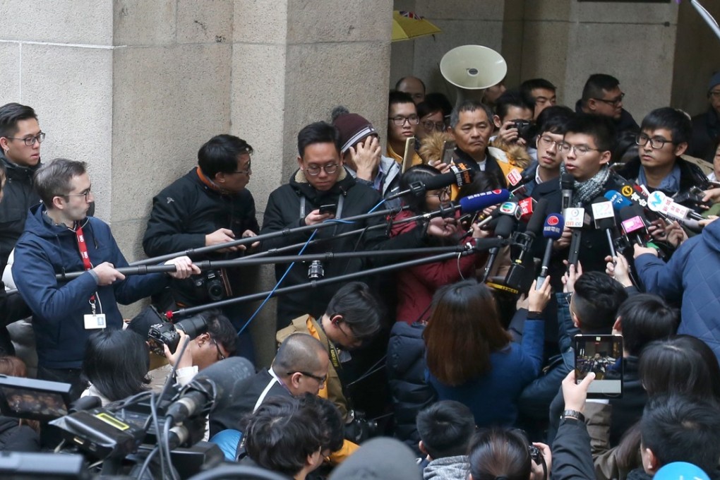 Nathan Law, Joshua Wong and Alex Chow meet the media outside the Court of Final Appeal. Photo: David Wong