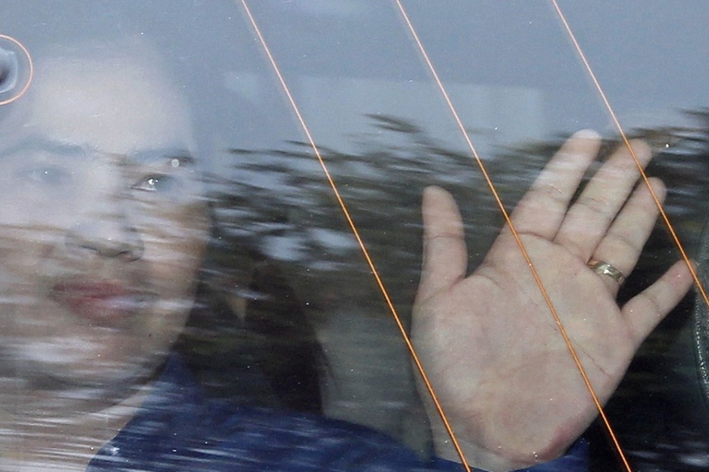 Cambodian land rights activist Tep Vanny waves from a police van as she leaves the Supreme Court in Phnom Penh. Photo: EPA