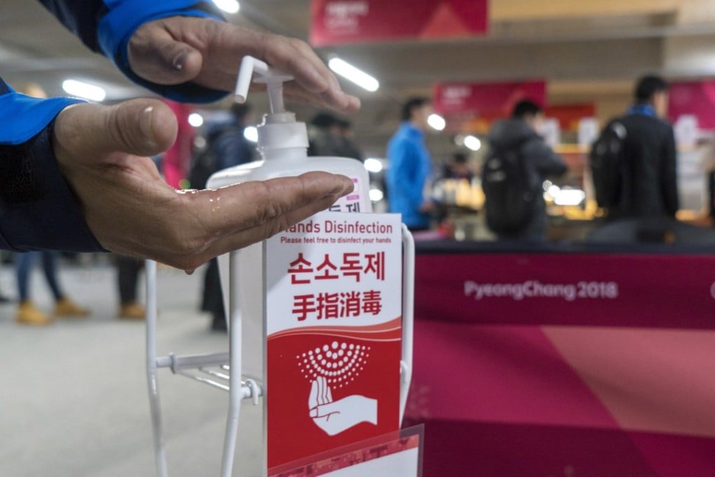 A man sanitises his hands at the entrance to the media cafeteria in Gangneung, South Korea, ahead of the Pyeongchang Olympics. Photo: AP