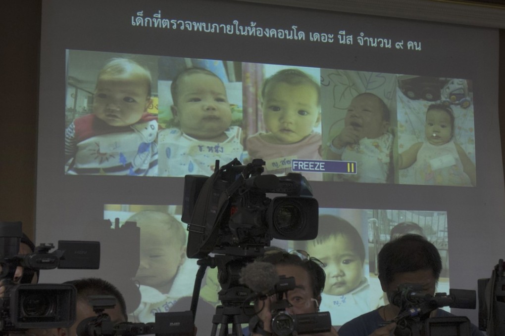 In this Tuesday, August 12, 2014 photo, Thai police display pictures of surrogate babies born toMitsutoki Shigeta, who is at the centre of a surrogacy scandal. Photo: AP