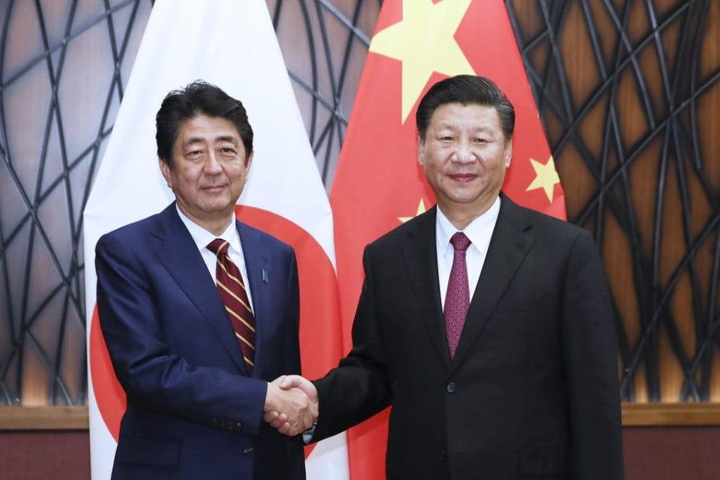 Japanese Prime Minister Shinzo Abe shakes hands with Chinese President Xi Jinping in Da Nang, Vietnam, on November 11, 2017. The two leaders of the long-time rivals have been increasingly cordial recently, but how interested are they really in a mutually beneficial relationship? Photo: Xinhua
