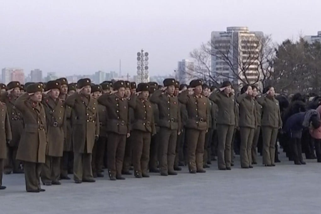 North Korean military personnel salute as they lay flowers in front of giant statues of Kim Il-sung and Kim Jong-il on Mansu Hill in central Pyongyang. Photo: AP