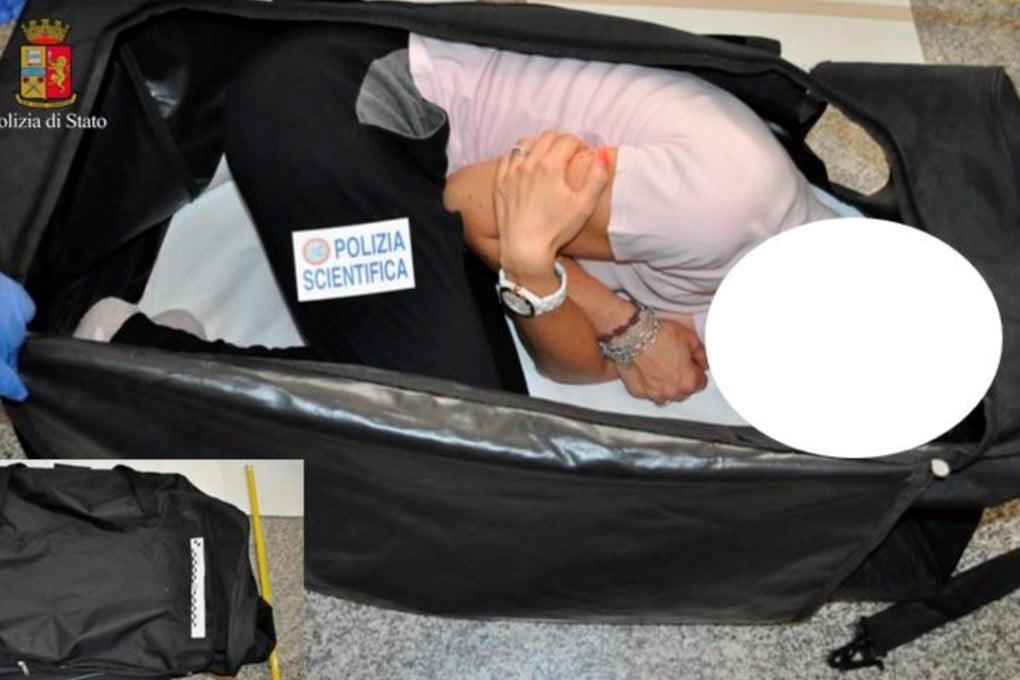 An Italian police officer takes part in a re-enactment showing how a kidnapped British model was allegedly kept in a bag, in this handout picture provided by the Italian Police in Milan. Photo: Reuters