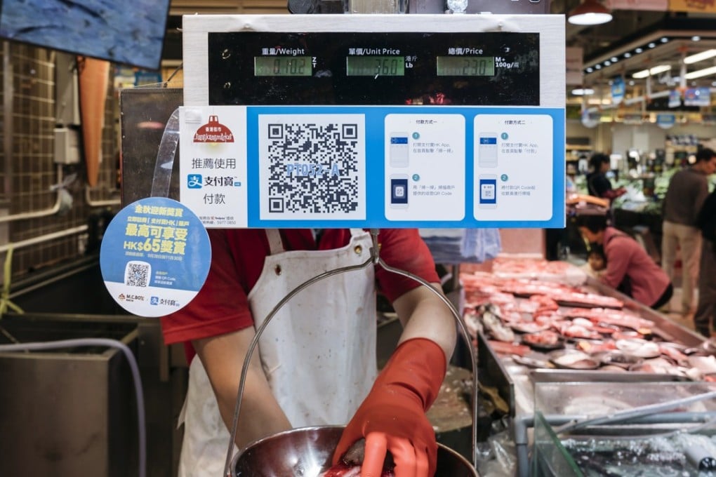 Instructions for cashless payment at a fishmonger in Hong Kong. Cash machine network operator JETCO is the latest company to offer an electronic payment system in the city as such payment systems gradually become more accepted. Photo: Bloomberg