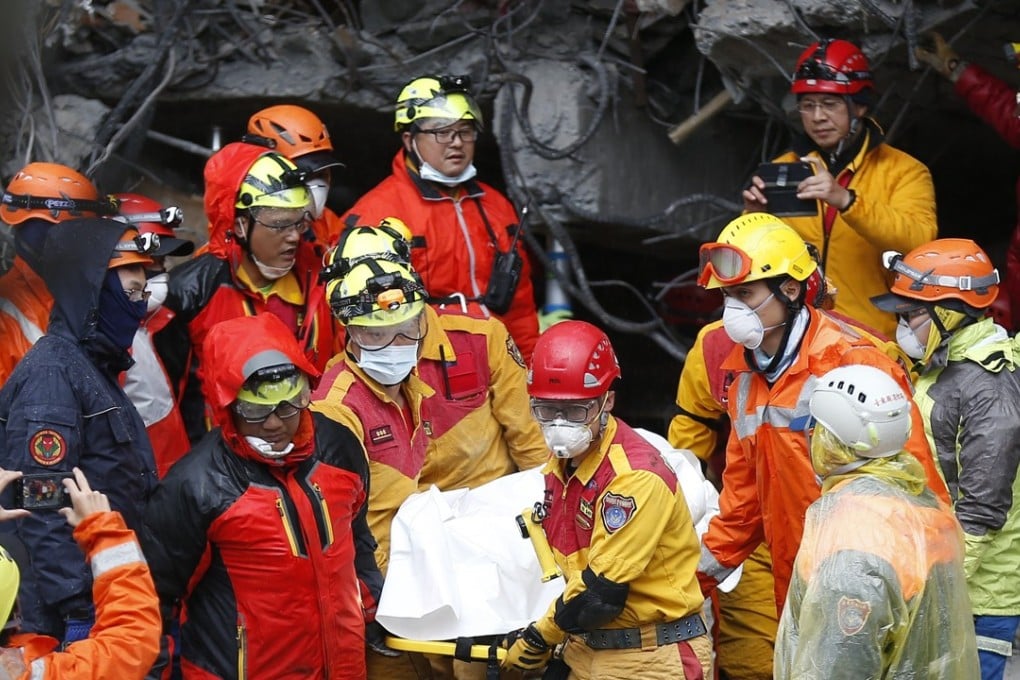 Rescue workers recover a body from a damaged building in Hualien on Wednesday. Photo: EPA-EFE