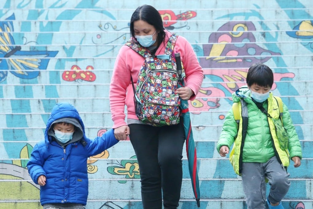 A woman aad children wearing masks leave a school in Wan Chai during the seasonal flu outbreak. Photo: David Wong