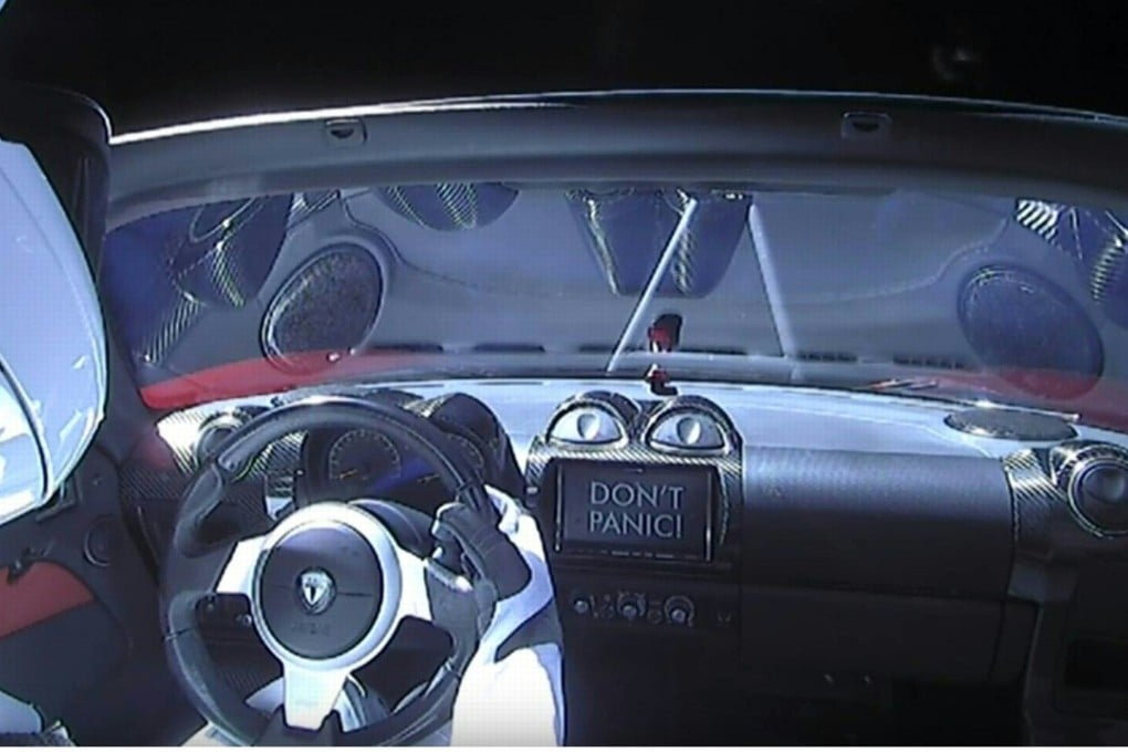 This still image taken from a SpaceX livestream video shows the Starman dummy astronaut sitting in SpaceX CEO Elon Musk’s cherry red Tesla roadster after the Falcon Heavy rocket delivered it into space on Tuesday. The on-screen display message “Don’t Panic!” pays homage to the sci-fi comic novel Hitchhiker’s Guide to The Galaxy. Photo: AFP