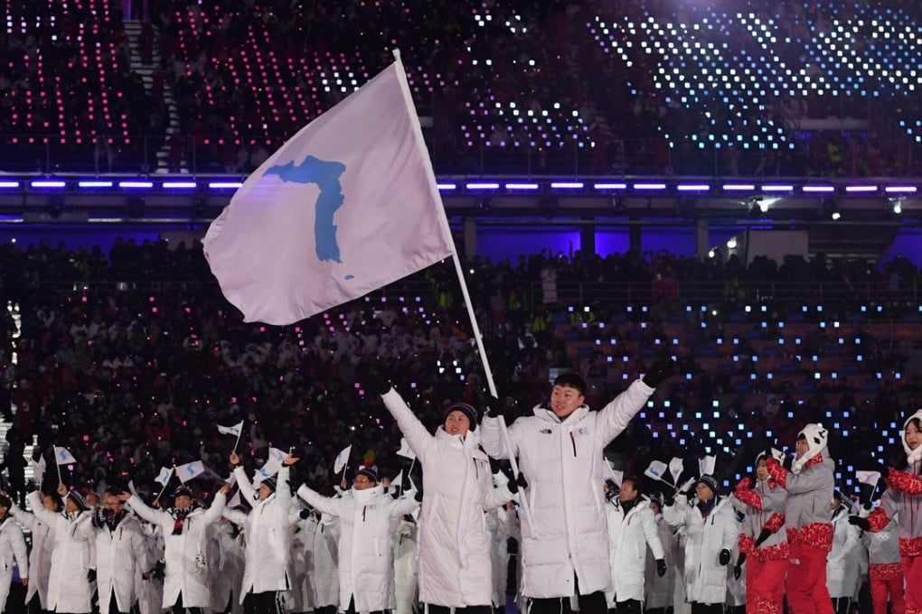 Unified Korea's flagbearers (North Korea's ice hockey player) Hwang Chung Gum (L) and (South Korea's bobsledder) Won Yun-jong (R) lead the parade during the opening ceremony of the Pyeongchang 2018 Winter Olympic Games. Photo: AFP