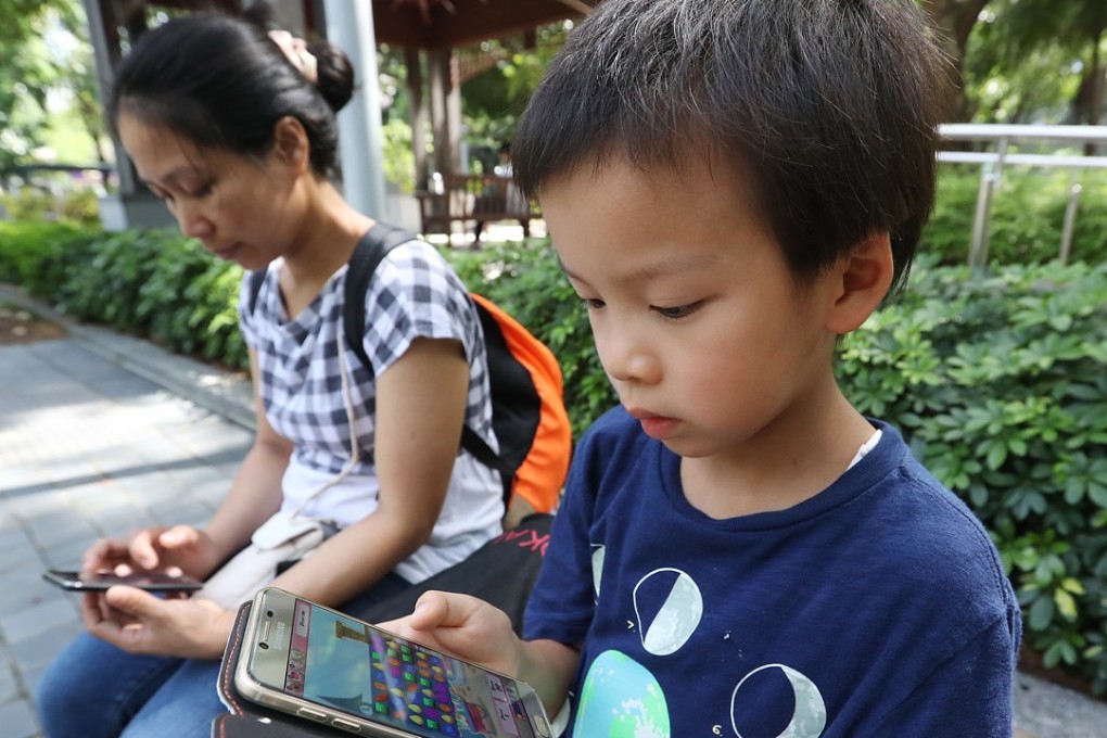 Mobile devices have become “essentials” for children nowadays. Photo: Edward Wong