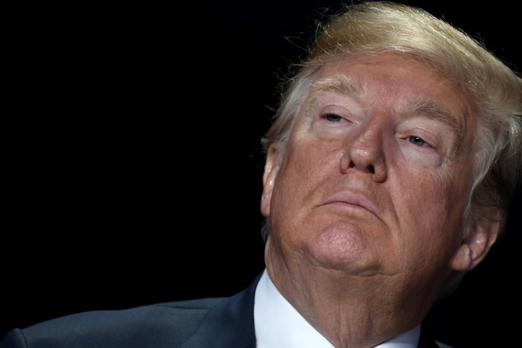 US President Donald Trump listens during the National Prayer Breakfast in Washington on Thursday. His administration may make it harder for foreigners who have taken benefits to get permanent US residency. Photo: Pool via Bloomberg