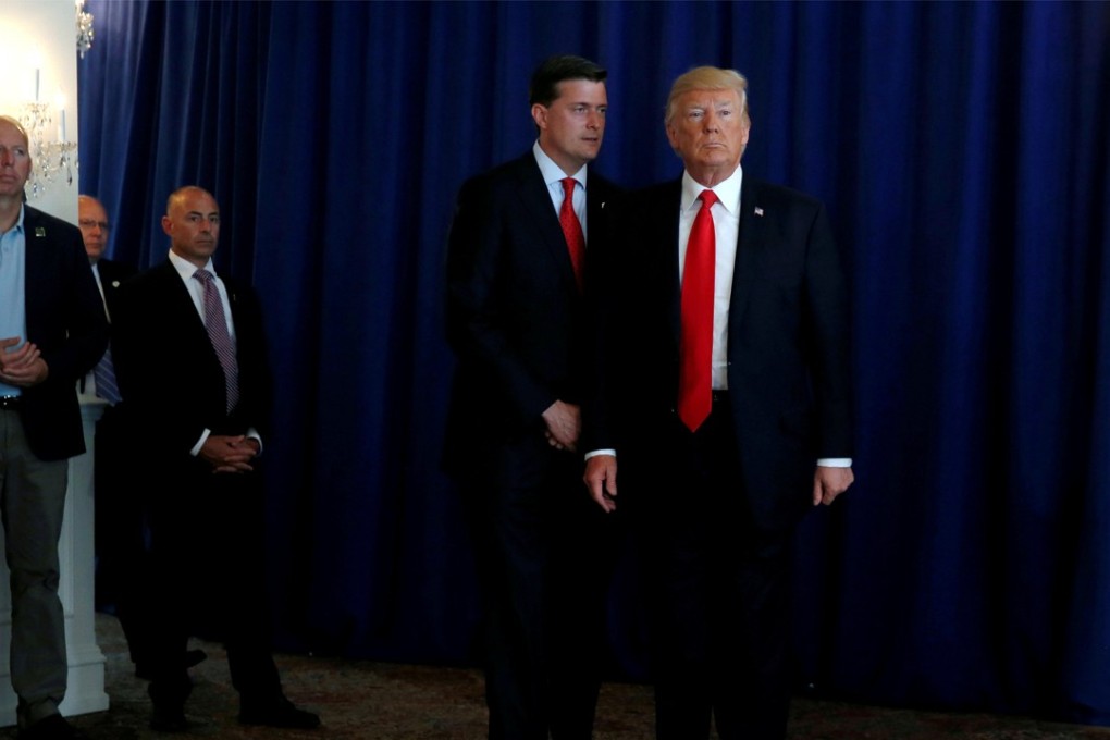 White House Staff Secretary Rob Porter (centre left) reminds US President Donald Trump of a bill he needs to sign in August 12 last year. Trump commended Porter on Friday after the latter left the White House following claims that he abused his ex-wives. File Photo: Reuters