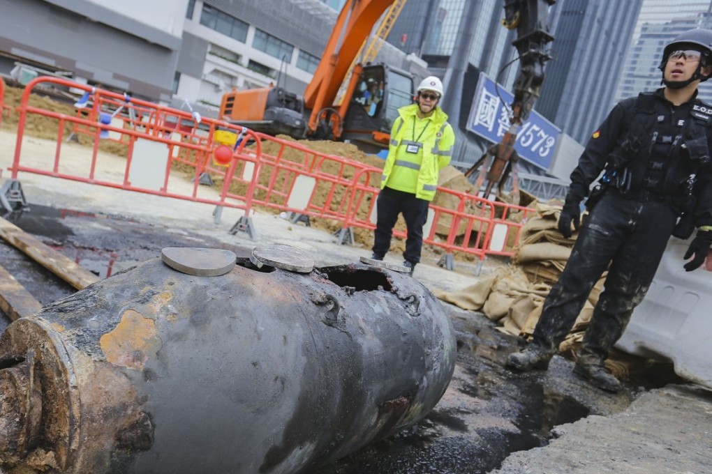 Officers defused one of the two bombs at the Wan Chai site by cutting a hole in its shell and burning off the explosives within. Photo: Dickson Lee
