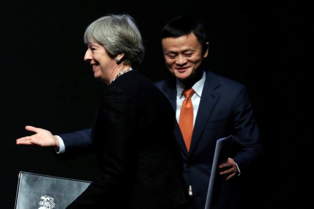 Alibaba's founder and Executive Chairman Jack Ma gestures as British Prime Minister Theresa May walks to the stage to deliver a speech at the China-UK business forum in Shanghai, China February 2, 2018. REUTERS/Stringer NO RESALES. NO ARCHIVES.
