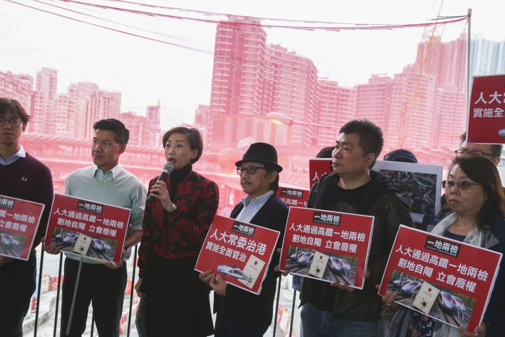 Lawmaker Tanya Chan (third from left, holding microphone) with fellow concern group members rallying against the joint checkpoint plan for the high-speed rail project. Photo: David Wong