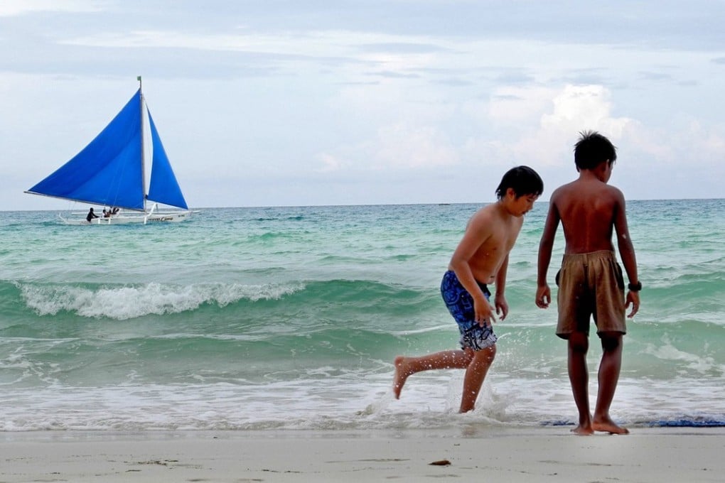 People enjoying themselves along a beach in Boracay. Photo: TNS