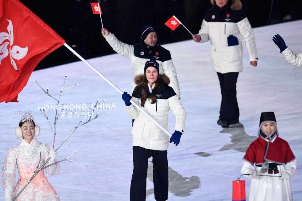 Hong Kong’s flagbearer Arabella Ng will have to wait to compete in the alpine skiing giant slalom. Photo: AFP