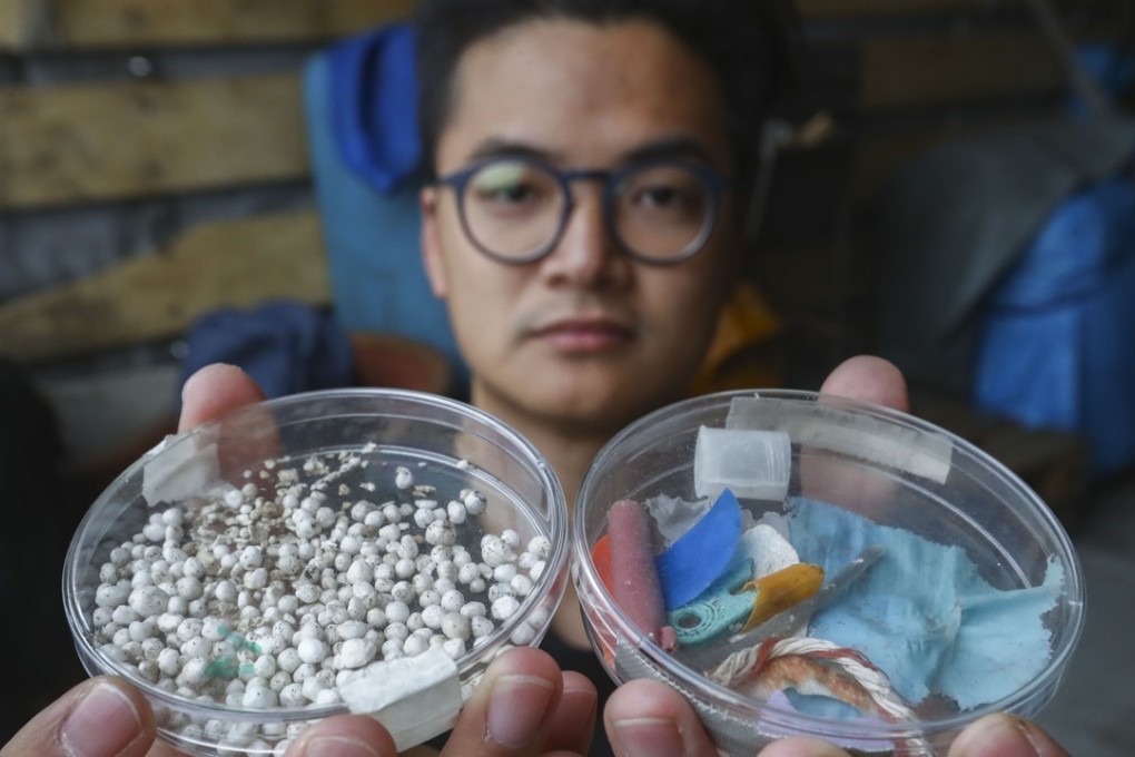 A Greenpeace campaigner with plastic collected in Hong Kong waters. Photo: Nora Tam