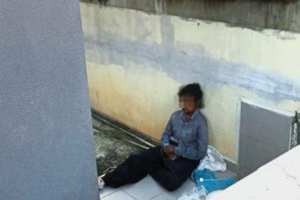 A terrible state: A picture of the allegedly abused maid sitting at the porch of the house in Taman Kota Permai, taken by one of Bukit Mertajam MP Steven Sim’s assistants. Photo: The Star