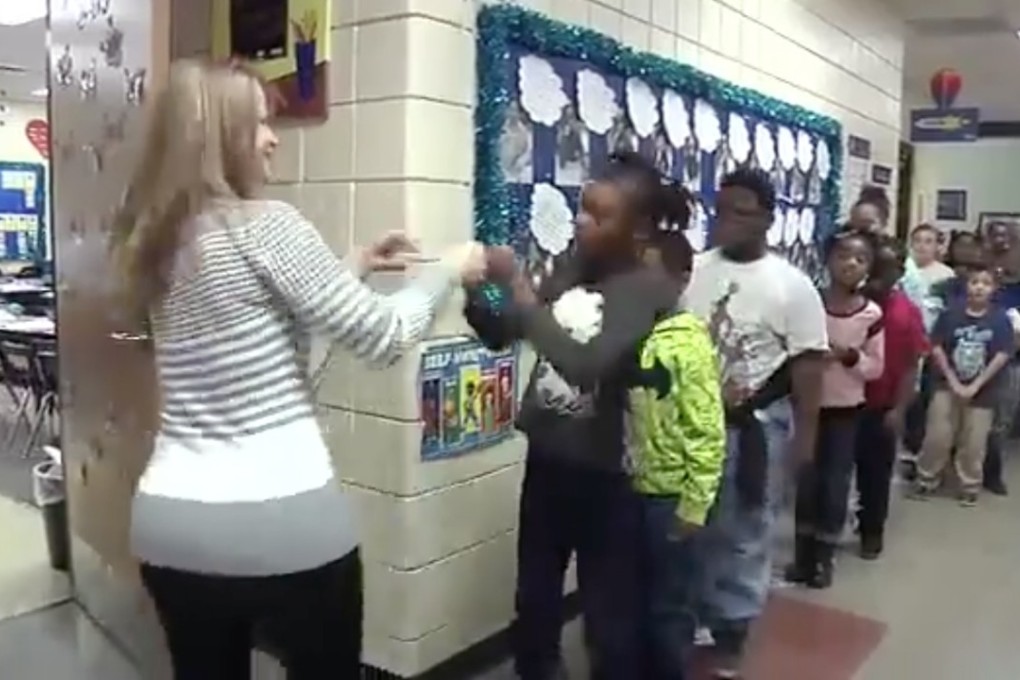 Wichita Public Schools teacher does an individual handshake every morning with her students before they start class. Photo: Facebook