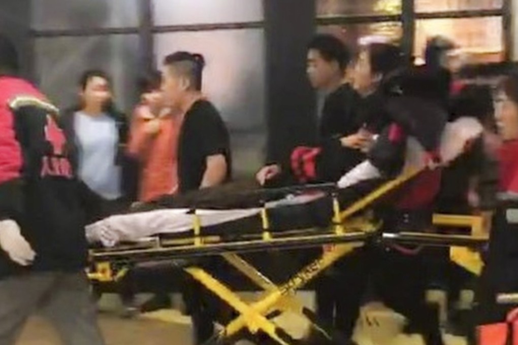 A victim of the knife attack at a shopping centre in Beijing is taken away by paramedics. Photo: Weibo