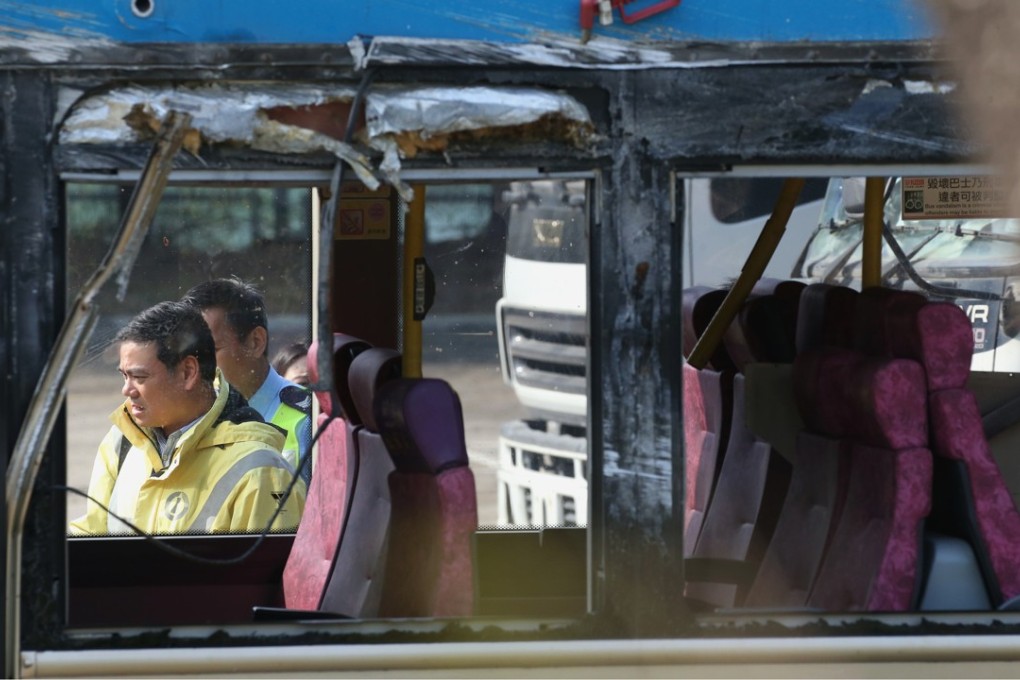 Officers from the Transport Department on Monday inspect the bus involved in the crash. Photo: David Wong