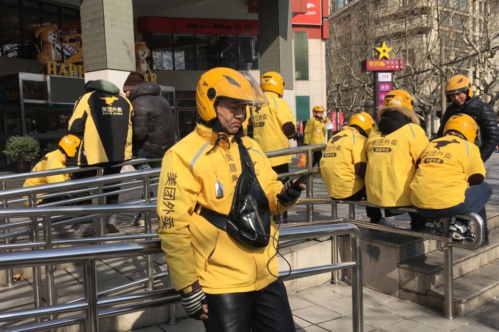 Wang Junqiang waits for his next food delivery order in Shanghai. Photo: Mandy Zuo
