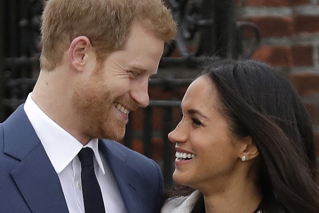 In this file photo dated November 27, Britain's Prince Harry and his fiancée Meghan Markle pose for photographers in the grounds of Kensington Palace in London. Photo: AP