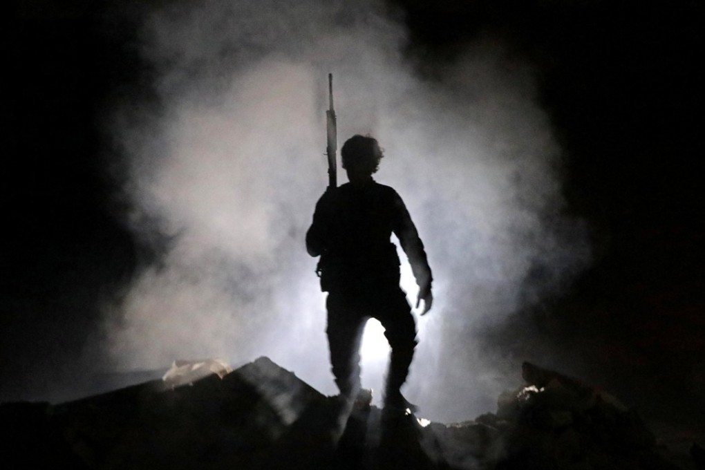 A raid by Russian mercenaries on a town held by US and coalition troops was thwarted with around 100 fatalities, none on the US side, American authorities said. Pictured: A Turkey-backed Free Syrian Army fighter seen in Syria on Monday. Photo: Reuters