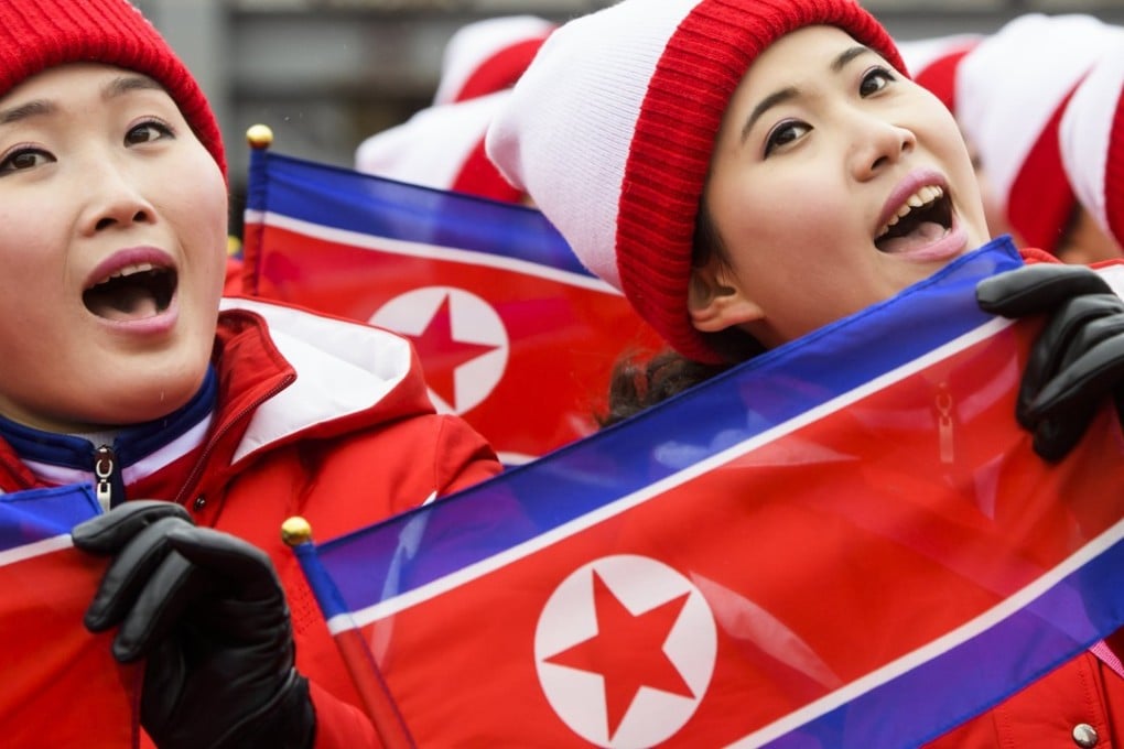 Members of the North Korean delegation wave flags in Pyeongchang. Photo: EPA
